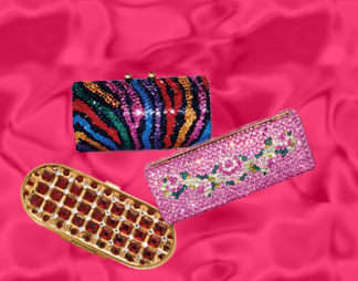 These lipstick cases feature Swarovski® crystals and black velveteen interior. There is a mirror on the inside of each case.